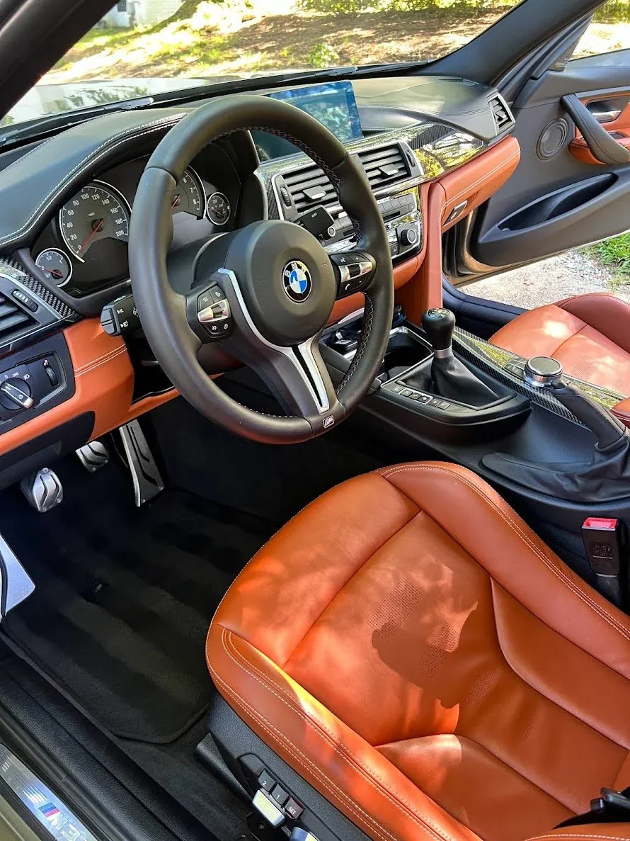 BMW interior with orange leather seats detailed